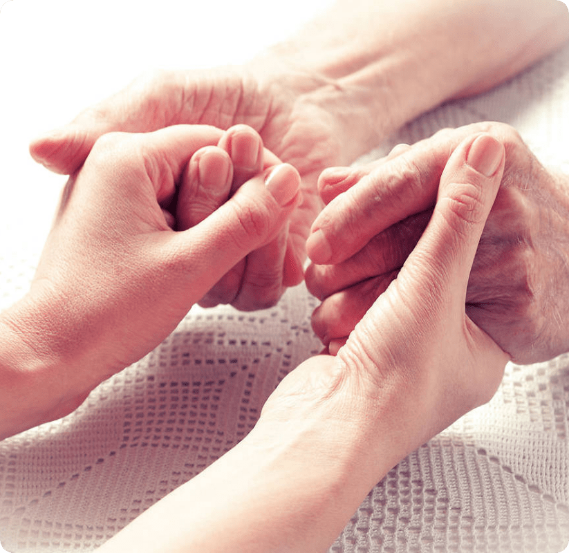 a person holding a hand of cancer patient